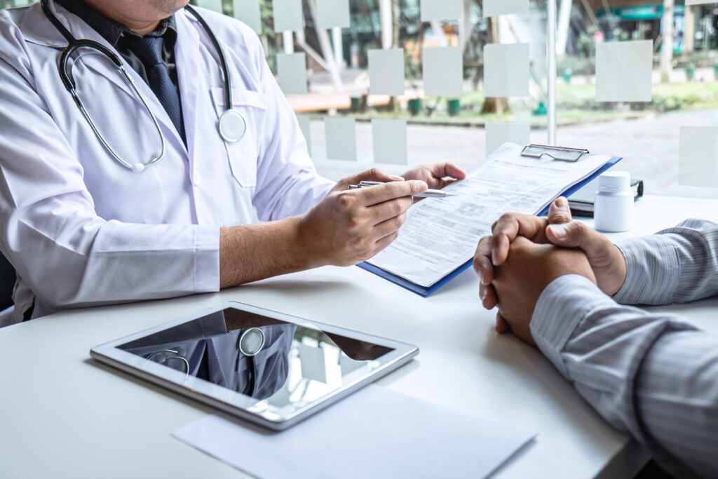 A doctor explaining about ESWT to a man experiencing ED